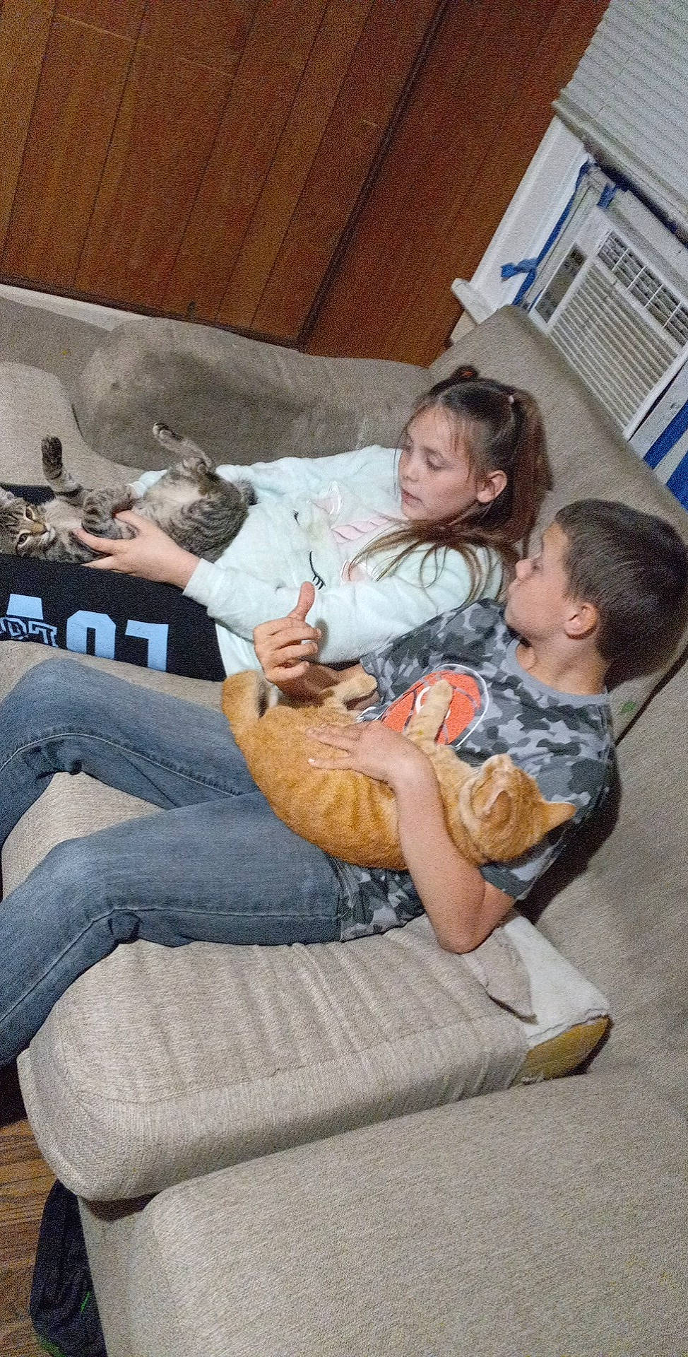 Jasmin is registered to the contest to win money with this photo: child, comfort, couch, flooring, fun, human_leg, jeans, joint, knee, lap, leg, leisure, living_room, mammal, person, room, sitting, sneakers, thigh, toddler