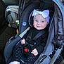 baby, car_seat, child, infant, blue_eyes, headband, bow, black_clothing, polka_dot_pants, sparkly_shoes, car_interior, seatbelt, safety, smile, cute, face, hands, footwear, sitting, young_child