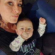 Kaeli Rose joined the competition — help win amazing prizes! baby, woman, child, indoor, portrait, person, clothing, shirt, sitting, blue_chair, hand, face, eyes, expression, casual, playful, pout, holding, warm_lighting, closeup