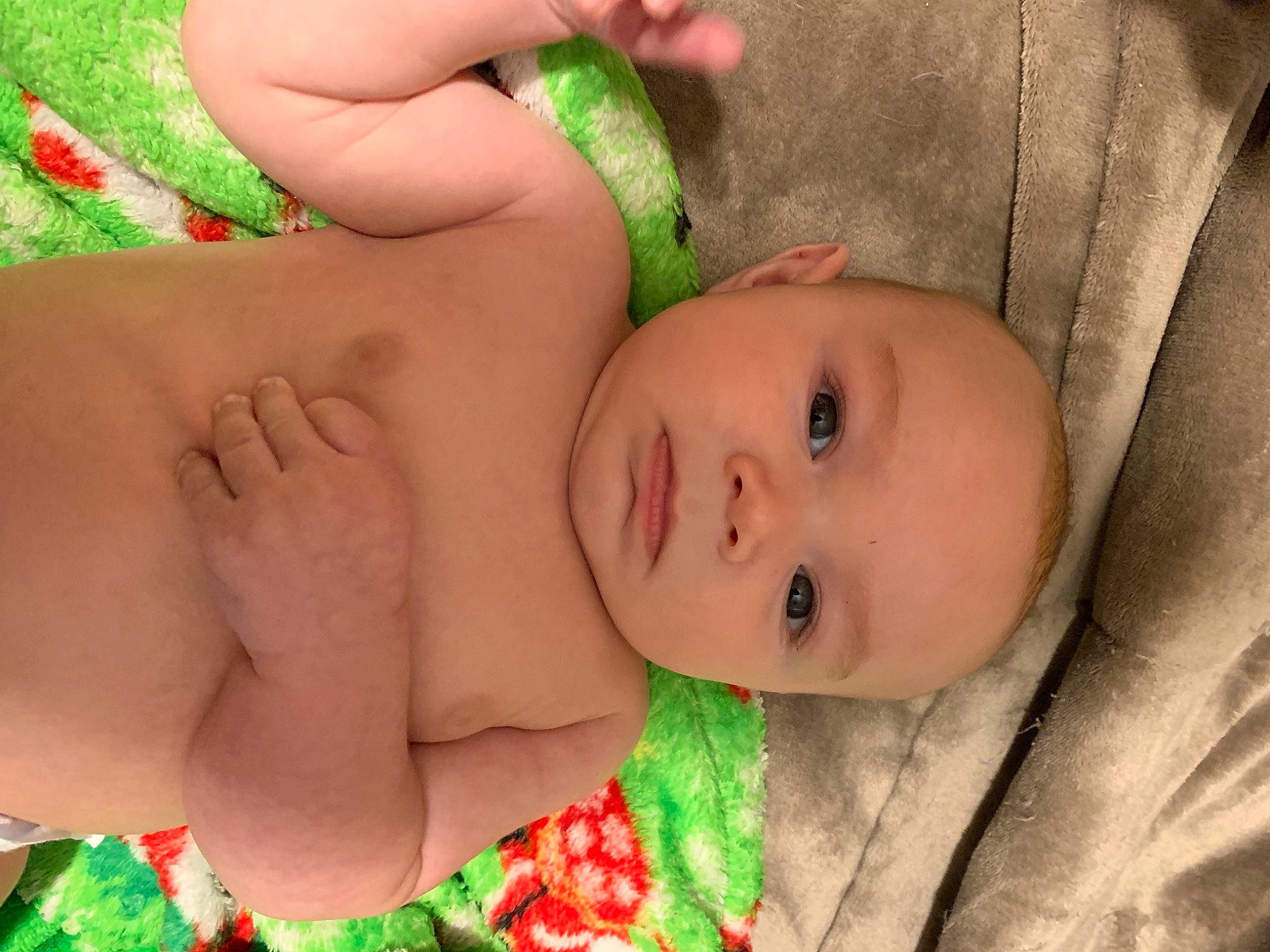 Colten is registered to the contest to win money with this photo: abdomen, baby, baby_toddler_clothing, chest, child, comfort, eye, facial_expression, finger, grass, green, hand, human, human_body, mouth, organ, person, skin, thigh, toddler