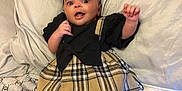 Alora joined the competition — help win amazing prizes! baby, bed, blanket, bow, child, cozy, cute, dress, fashion, happy, headband, indoors, infant, person, pillow, plaid, portrait, smile, socks, soft