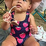 Leilani is registered to the contest to win money with this photo: toddler, child, swimsuit, hat, sunglasses, outdoor, blanket, sitting, curious, playful, summer, sunhat, legs, face, person, photography, nature, chair, colorful, towel