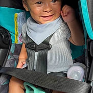 John joined the competition — help win amazing prizes! baby, car_seat, smiling, toy, bottle, striped_clothing, bib, seatbelt, infant, sunlight, happy, child, sitting, hand_raised, face, cute, indoor, safety, comfort, playful