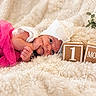 newborn, baby, infant, child, portrait, lying_down, sleeping, awake, smiling, pink_outfit, white_headband, large_bow, blanket, fluffy, wooden_blocks, one_month, milestone, baby_photography, indoor, plant