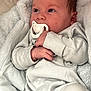 Lyam participe au concours pour gagner de l'argent avec cette photo : baby, bedding, blanket, button, cheek, cozy, ear, eyes, face, hair, hand, infant, lying_down, newborn, onesie, pacifier, portrait, skin, sleepwear, soft_texture