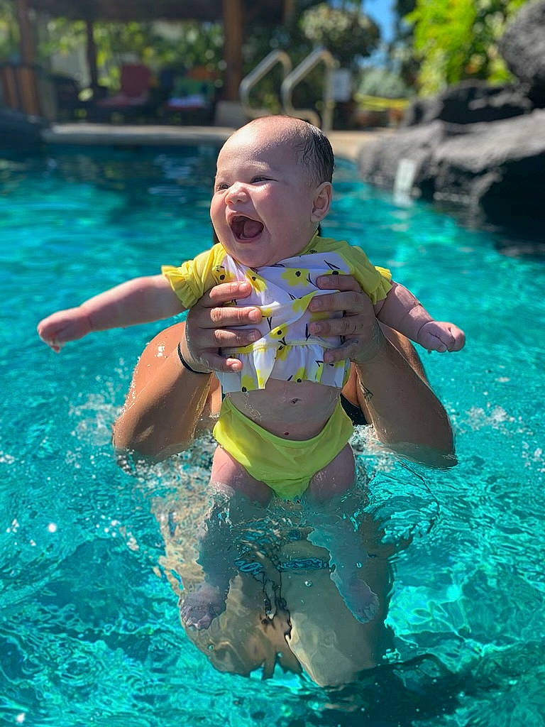 Mila-rose is registered to the contest to win money with this photo: aqua, baby, baby_toddler_clothing, bathing, child, fluid, fun, leisure, leisure_centre, mouth, muscle, people, person, play, recreation, summer, swimming_pool, toddler, turquoise, vacation
