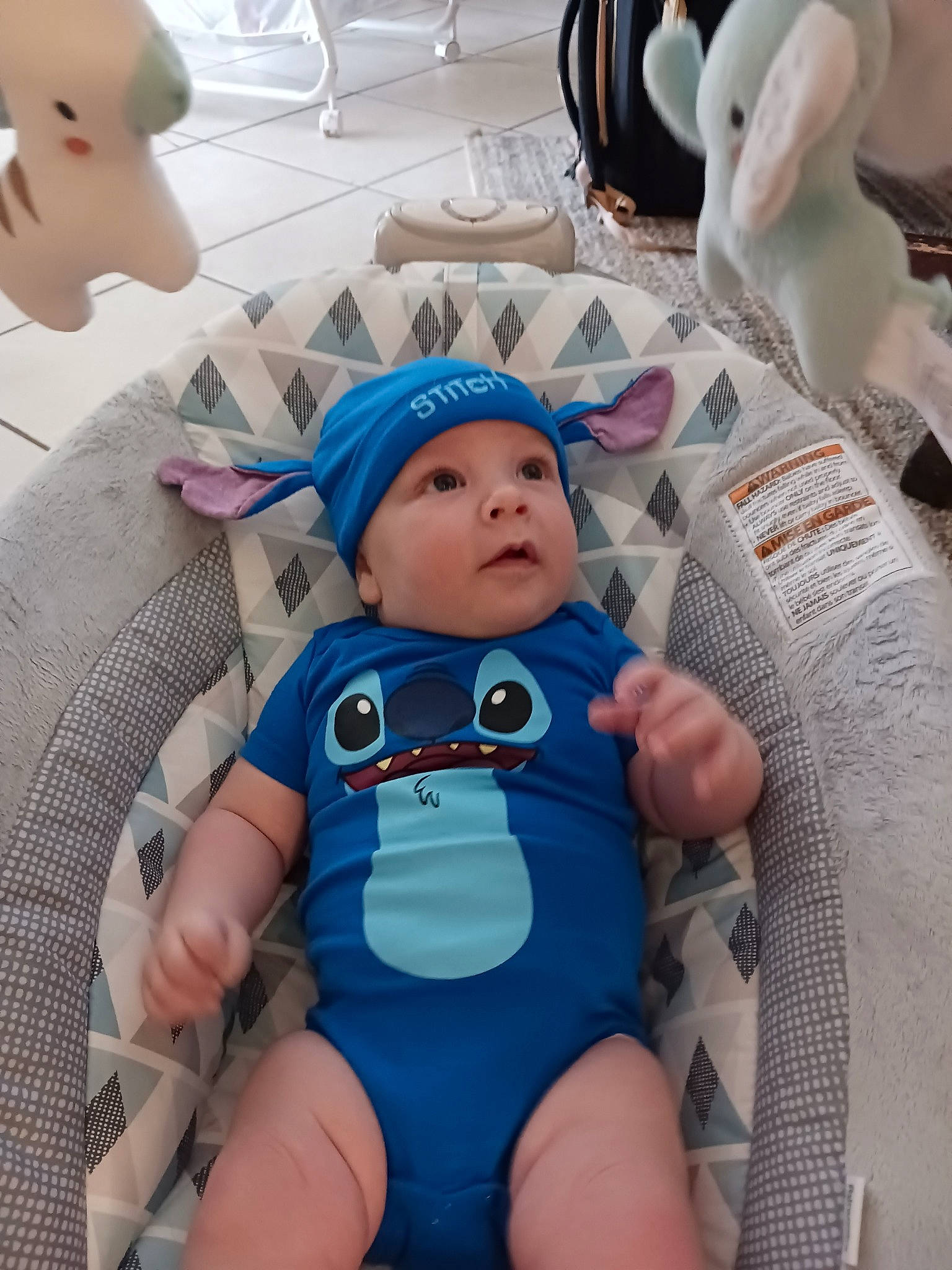 Liam is registered to the contest to win money with this photo: baby, baby_products, baby_safety, baby_toddler_clothing, cheek, child, comfort, hat, head, headwear, health_care, linens, person, room, service, sitting, skin, surprise, textile, thigh