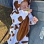 Hunter is registered to the contest to win money with this photo: baby, sleeping, onesie, giraffe_costume, pacifier, outdoor, camping_chair, child, cute, infant, resting, grass, fabric, footed_pajamas, animal_print, hand, face, head, soft, relaxation