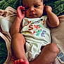baby, infant, blanket, onesie, foot, hand, face, skin, newborn, cute, sleepy, soft, cozy, clothing, lying_down, closeup, child, person, indoors, resting