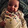 baby, infant, smile, face, clothing, onesie, cute, child, pattern, blanket, lying, happy, person, young, indoor, portrait, hand, cozy, soft, animal_print