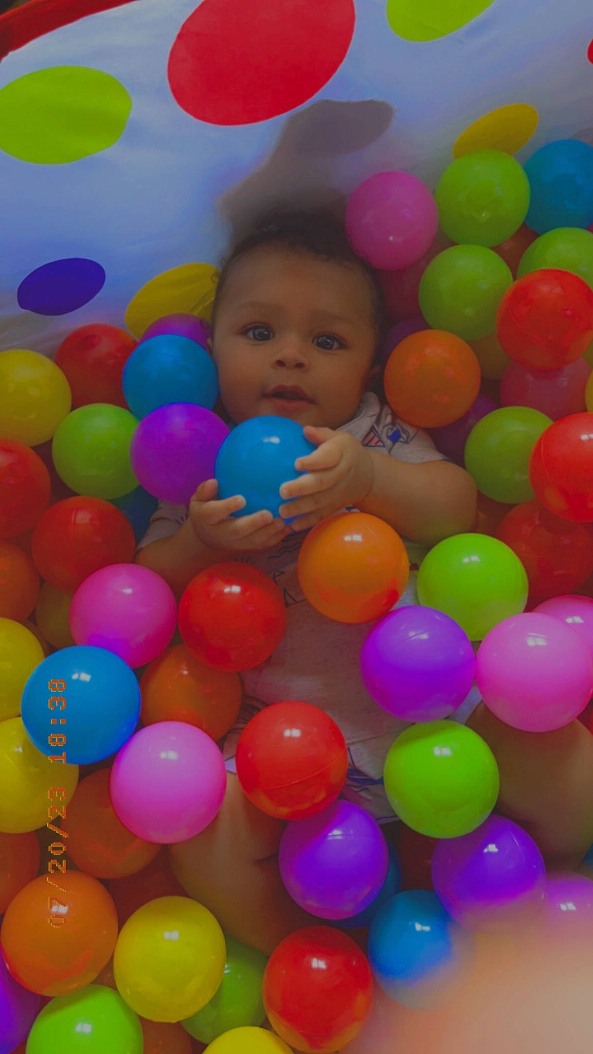 Derek is registered to the contest to win money with this photo: baby, baby_toys, ball_pit, balloon, child, circle, event, fun, happy, leisure, magenta, mixture, party_supply, pattern, person, plastic, play, playground, toddler, toy