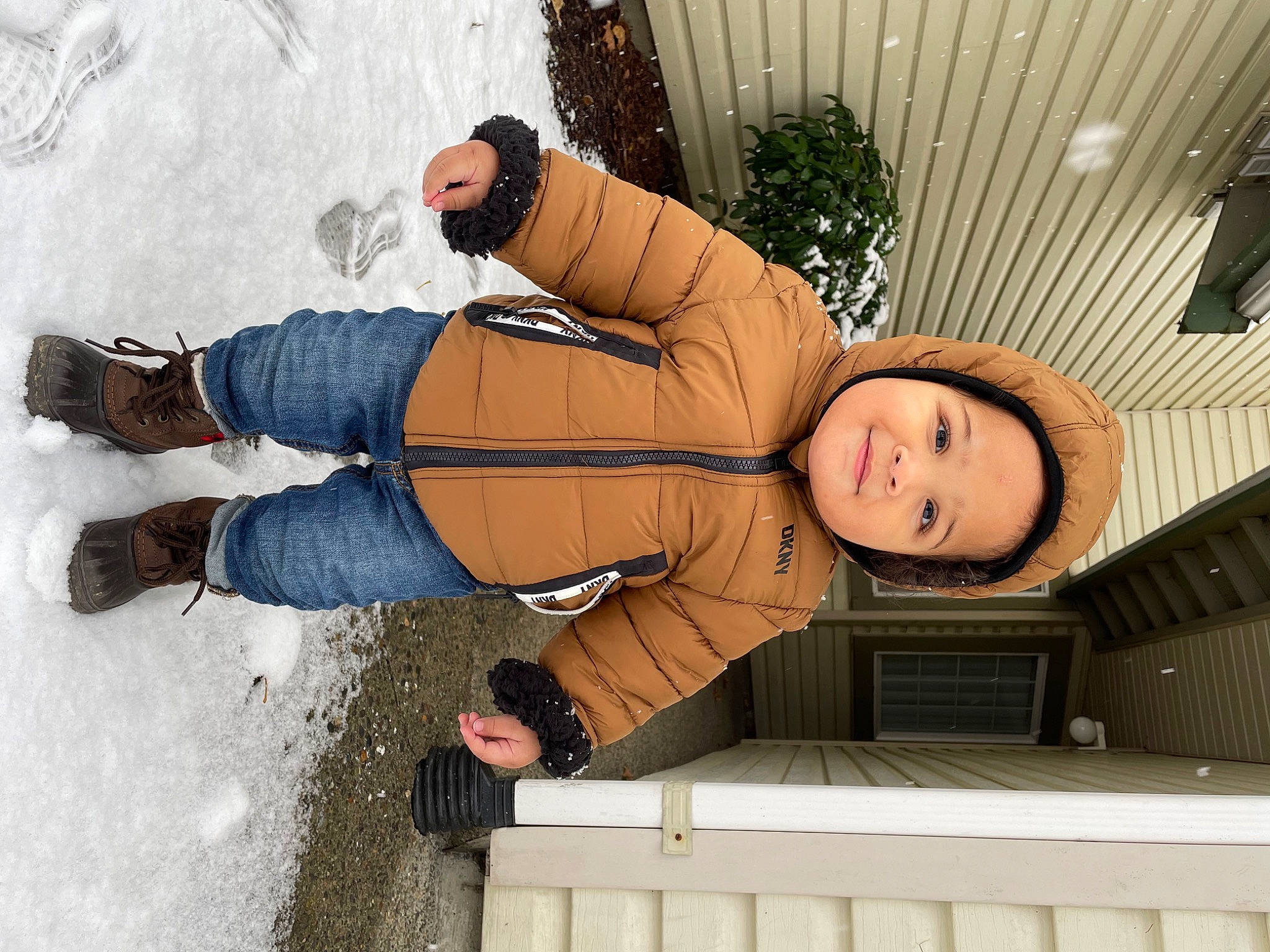 Gregory is registered to the contest to win money with this photo: boot, child, cool, denim, fashion, flash_photography, fun, glove, happy, human_leg, knee, leisure, person, sitting, smile, thigh, toddler, vacation, winter, wood