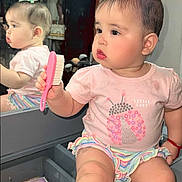 Cindy joined the competition — help win amazing prizes! baby, child, mirror, reflection, brush, pink, tshirt, skirt, hair_accessory, vanity, makeup, furniture, indoor, cute, portrait, sitting, expression, face, person, lighting