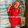 Vincent is registered to the contest to win money with this photo: baby, infant, red_clothing, onesie, striped_towel, baby_wipes, couch, lying_down, small_hands, cute, indoors, child, portrait, face, expression, white_socks, fabric, playful_text, soft_texture, newborn