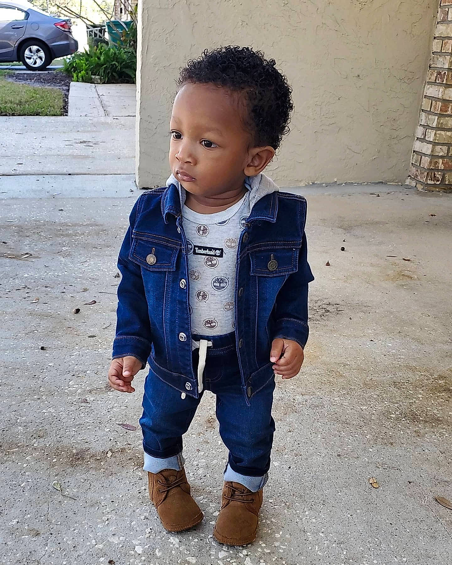 Khylen is registered to the contest to win money with this photo: asphalt, baby_toddler_clothing, child, cool, denim, electric_blue, face, happy, head, outerwear, pattern, person, road_surface, sitting, sleeve, street_fashion, t_shirt, tire, toddler, waist
