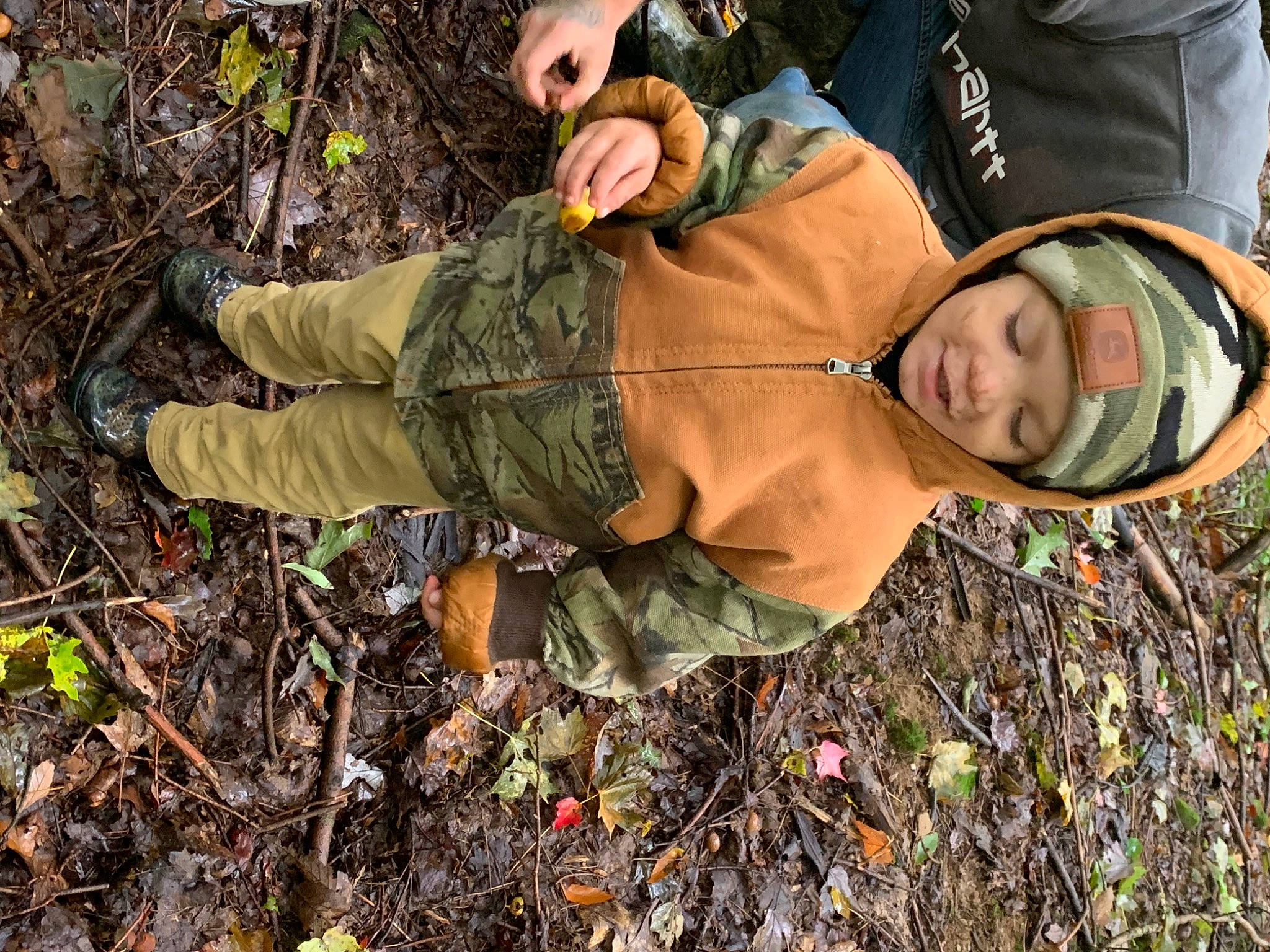 Waylon joined the competition — help win amazing prizes! adaptation, camouflage, deciduous, forest, glove, grass, hat, headwear, military_camouflage, pattern, people_in_nature, person, personal_protective_equipment, sleeve, smile, sneakers, soil, soldier, tree, wood