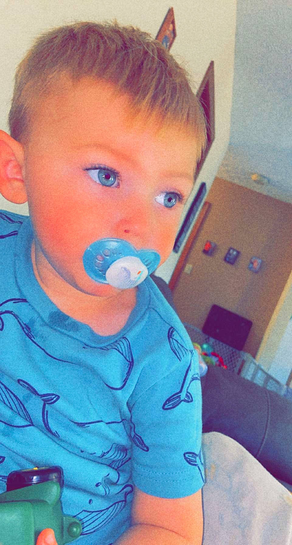 Konner is registered to the contest to win money with this photo: arm, azure, baby_toddler_clothing, cheek, cool, drinkware, ear, eye, eyelash, fun, hair, happy, jaw, mouth, neck, nose, person, shoulder, skin, t_shirt