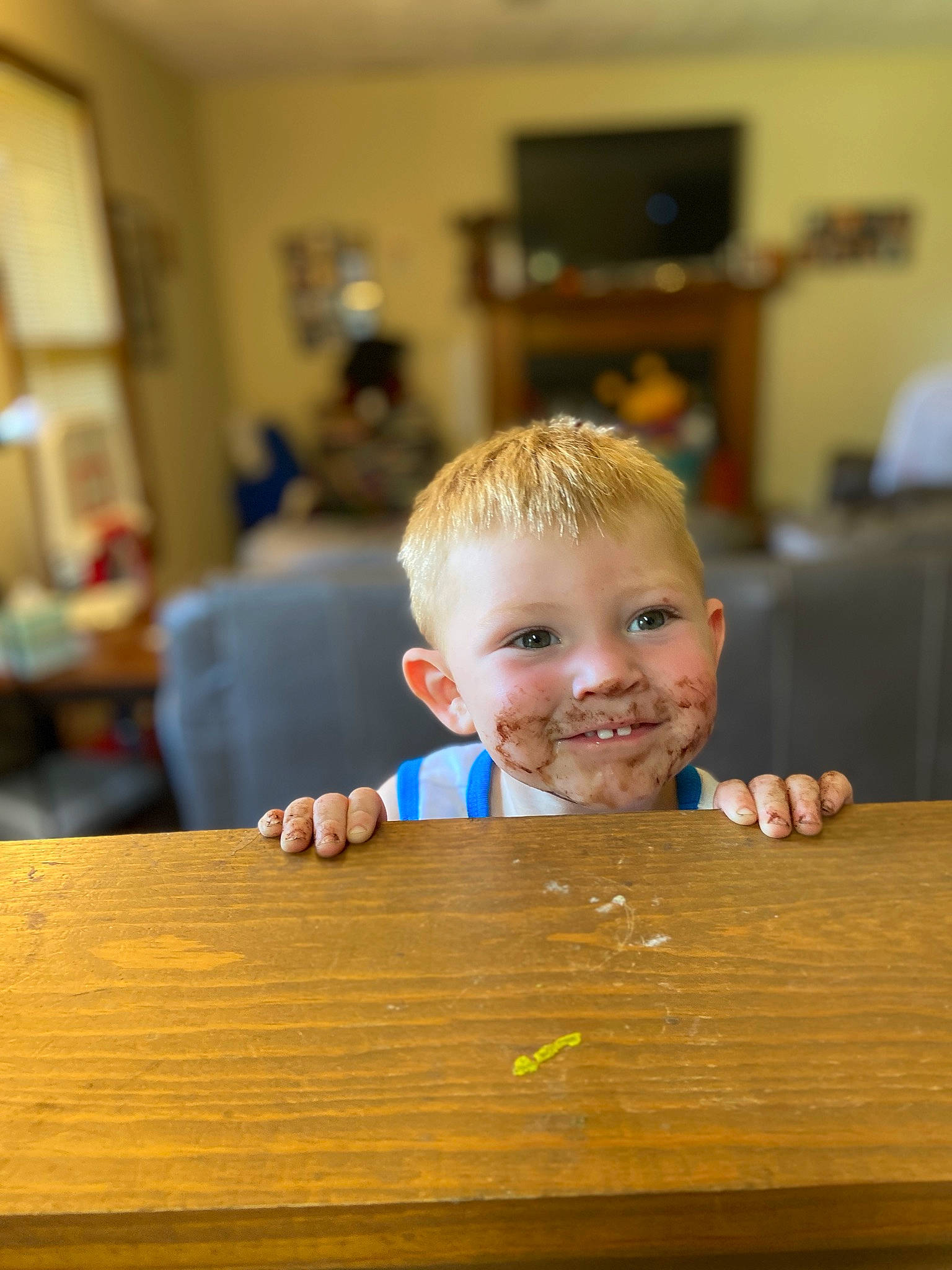 Konner is registered to the contest to win money with this photo: cheek, chin, eye, floor, flooring, fun, hair, happy, hardwood, iris, joy, nose, person, picture_frame, skin, smile, table, television, toddler, varnish
