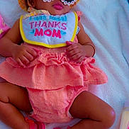 Amoura is registered to the contest to win money with this photo: baby, infant, sunglasses, hat, bib, dress, shoes, towel, pink, peach, clothing, accessories, child, cute, relaxing, indoor, person, fashion, summer, adorable