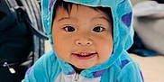 Athena is registered to the contest to win money with this photo: toddler, child, costume, onesie, monster, blue, purple, crawling, carpet, indoors, smiling, cute, baby, face, eyes, hood, playful, soft, home, young