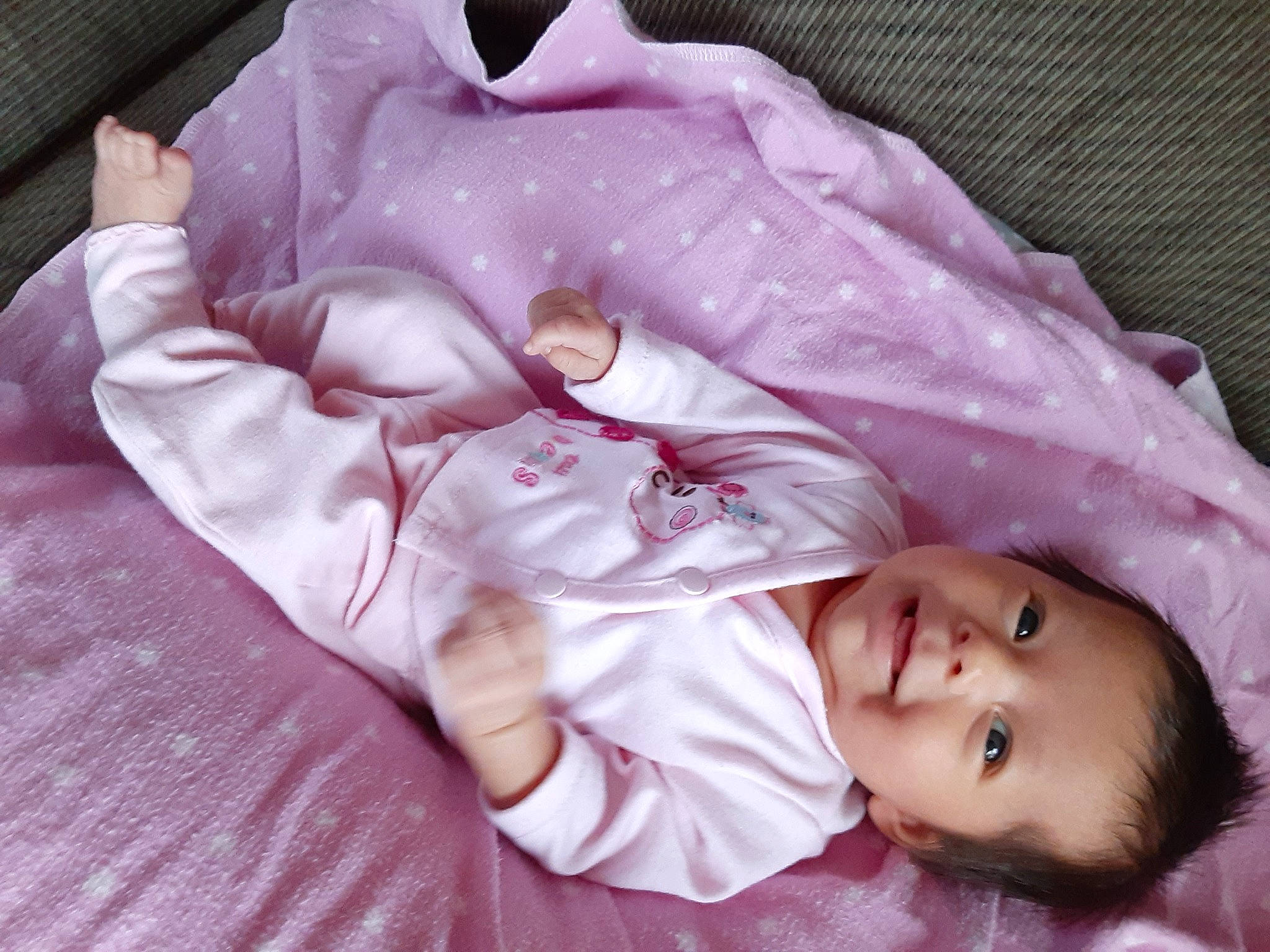 Lailani is registered to the contest to win money with this photo: baby, bed_sheet, bedtime, blanket, child, lilac, mouth, person, pink, plant, product, skin, sleep, smile, textile, toddler