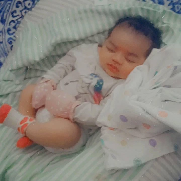 Harmoni is registered to the contest to win money with this photo: baby, baby_products, baby_sleeping, baby_toddler_clothing, bedding, bedtime, cheek, child, comfort, foot, linens, nap, pattern, person, room, skin, sleep, sleeve, textile, thumb