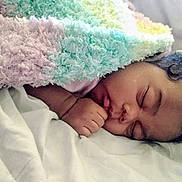 Ja'Zhyia joined the competition — help win amazing prizes! baby, sleeping, blanket, curly_hair, infant, bed, cozy, soft_texture, peaceful, child, closeup, face, hand, rest, indoors, cute, warm, snuggle, pale, comfort
