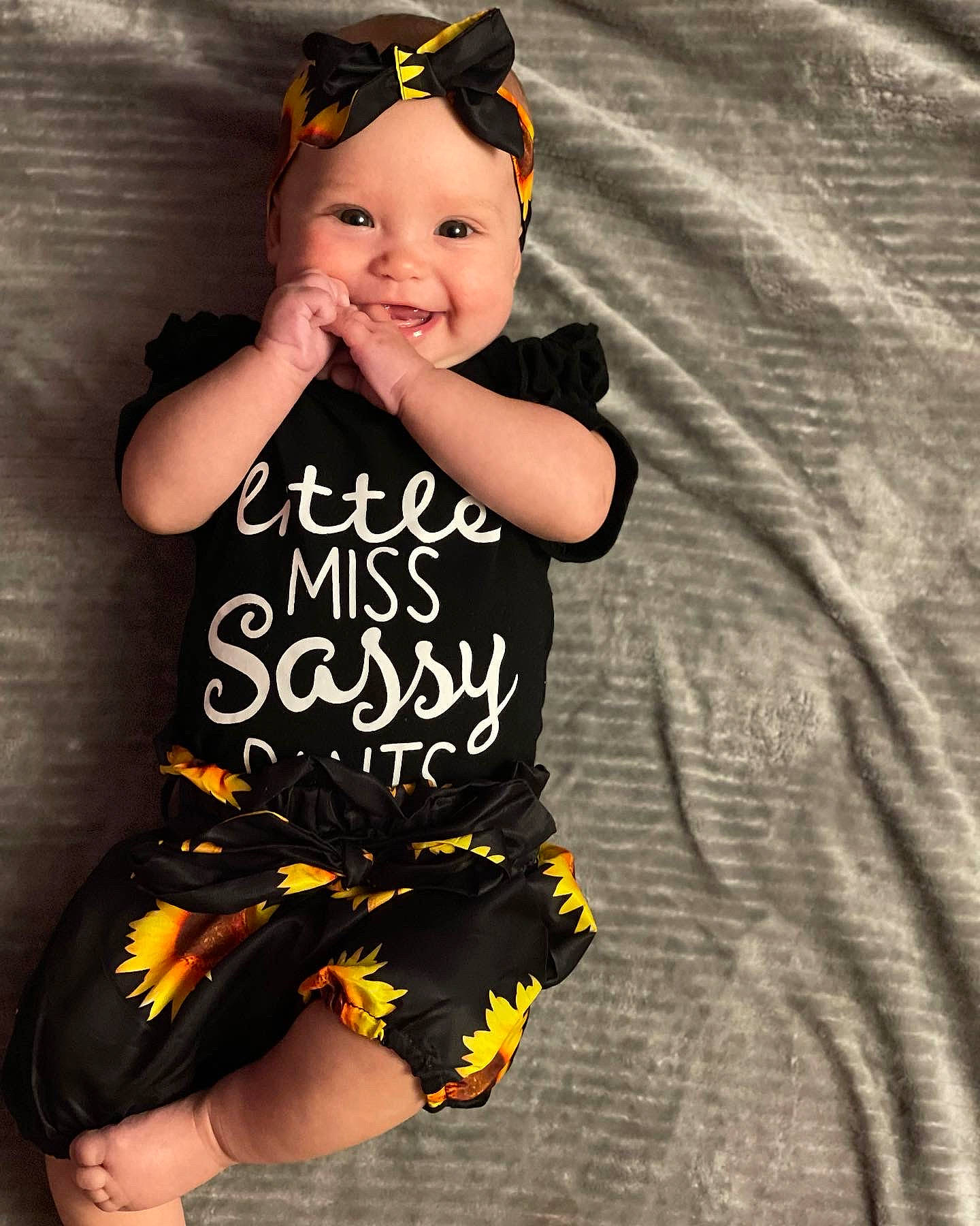 Harlyn joined the competition — help win amazing prizes! baby_toddler_clothing, black, day_dress, eyewear, face, facial_expression, flash_photography, goggles, happy, headwear, human_leg, joy, knee, one_piece_garment, pattern, person, sleeve, smile, t_shirt, thigh