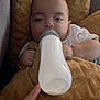 Luis a rejoint le concours — aidez-le/la à gagner de superbes lots ! baby, blanket, bottle, child, clothing, comfort, couch, cozy, face, feeding, finger, hand, indoors, infant, milk, person, pillow, relaxing, soft, toddler