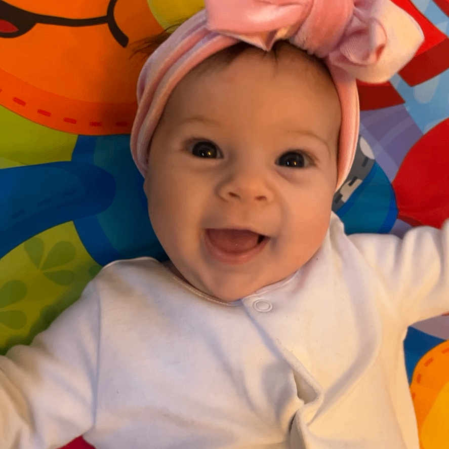 Florence is registered to the contest to win money with this photo: accessories, applique, baby, babylaughing, balloon, bandana, baseballcap, bathingcap, beanie, blanket, bodypart, bonnet, cap, clothing, costume, dress, face, finger, hand, happy
