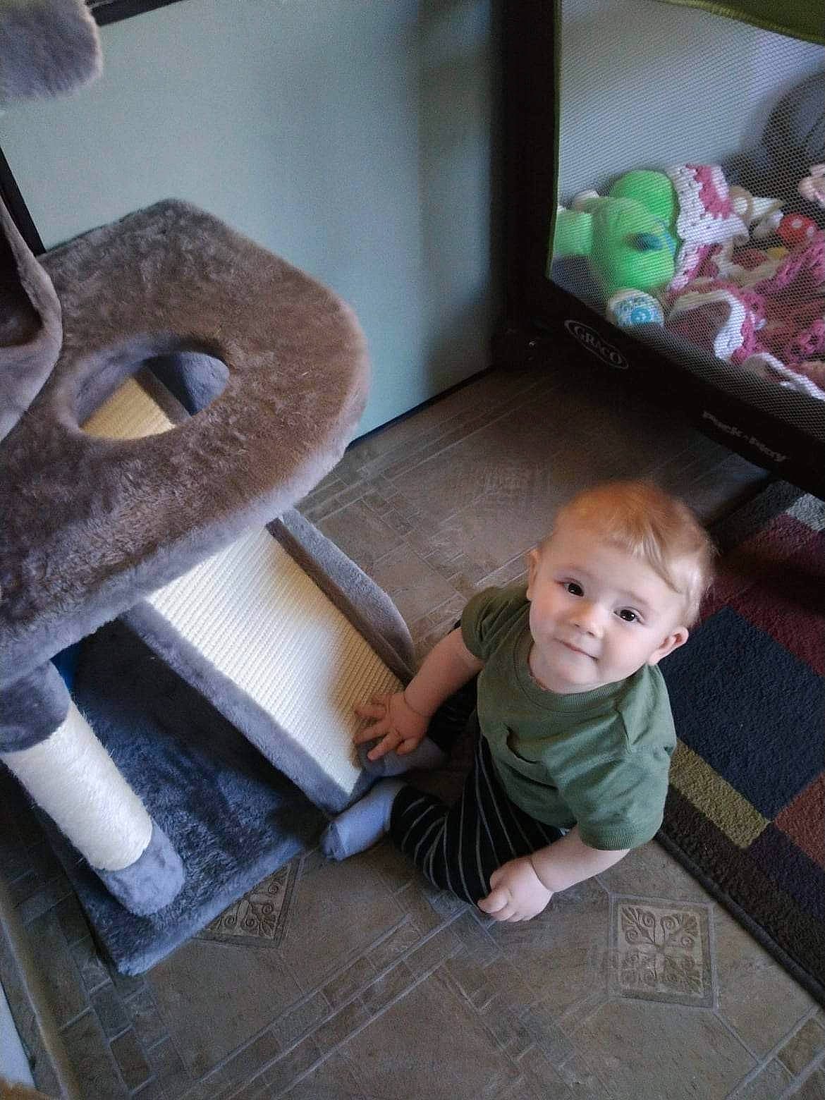 Jaxson joined the competition — help win amazing prizes! baby, chair, child, comfort, couch, flooring, green, hardwood, house, joy, linens, living_room, person, pillow, room, sitting, smile, textile, throw_pillow, toddler