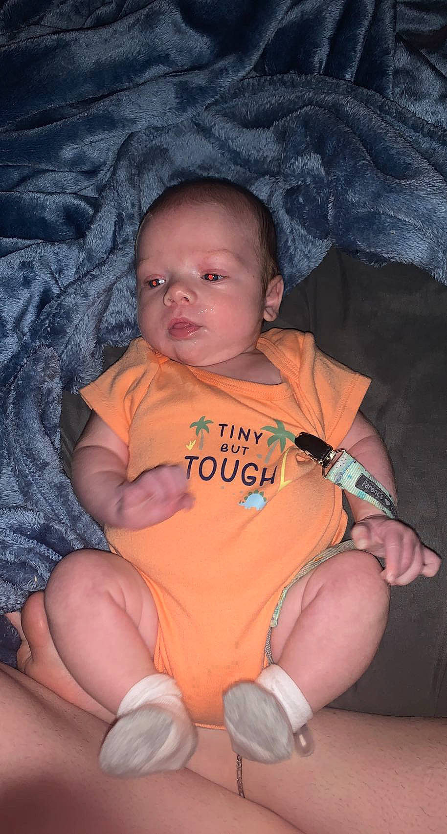 Braxton is registered to the contest to win money with this photo: baby, baby_toddler_clothing, cheek, chin, comfort, eye, finger, fun, hand, iris, lap, leg, mouth, nose, orange, person, skin, thigh, thumb, toddler