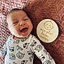 Elio participe au concours pour gagner de l'argent avec cette photo : baby, smile, onesie, animal_print, blanket, wooden_plaque, face, infant, happy, cute, lying_down, pattern, child, clothing, expression, portrait, indoors, skin, head, peaceful