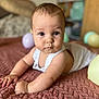baby, child, infant, face, eyes, arm, blanket, balloon, indoor, soft_light, closeup, portrait, curious, cute, skin, clothing, home, texture, focus, crawling