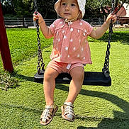 Maylie participe au concours pour gagner de l'argent avec cette photo : toddler, child, swing, hat, outdoor, grass, playground, sunlight, summer, pink_clothing, sandals, trees, chains, expression, cute, baby, nature, fun, daylight, park