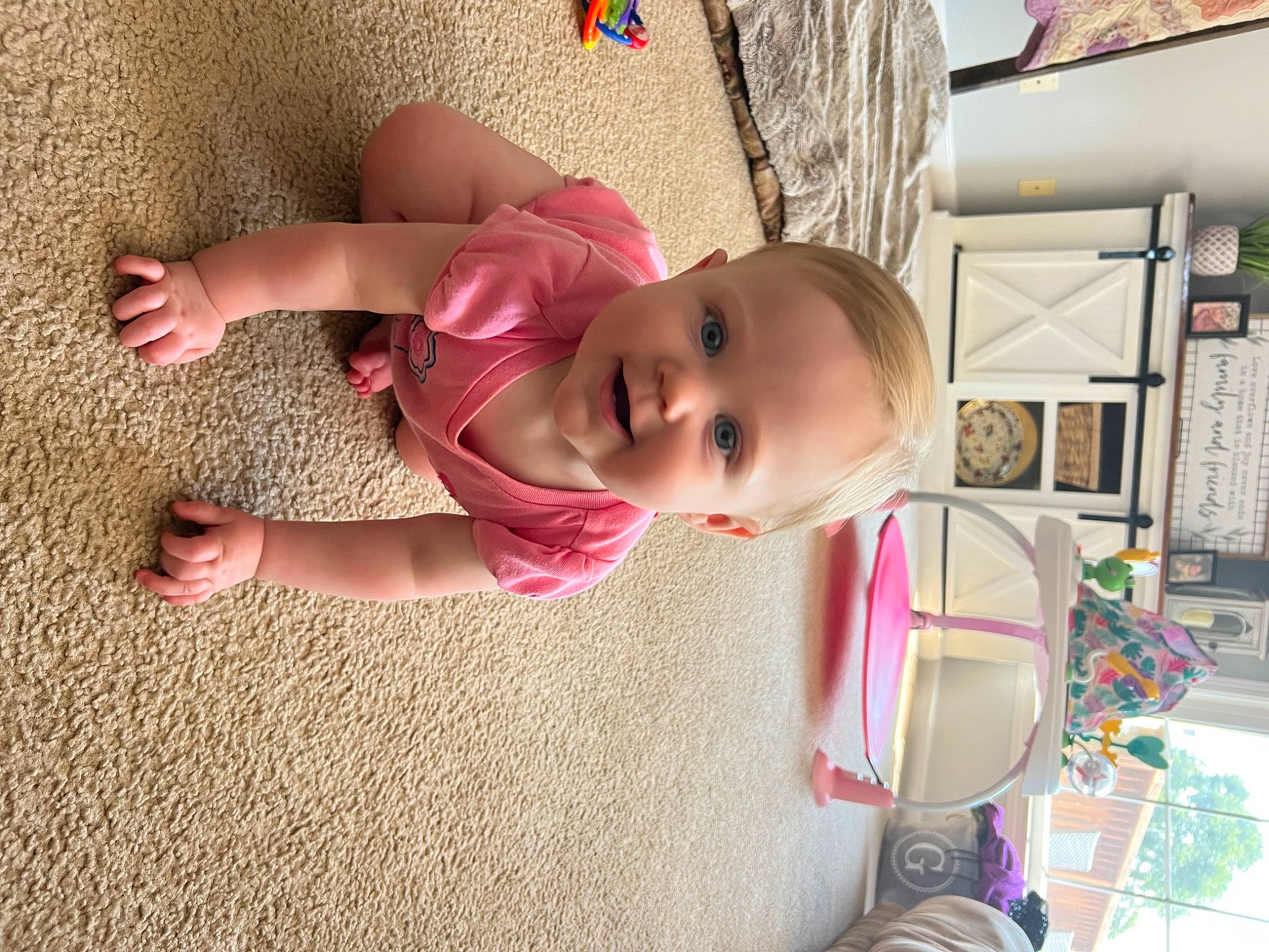 Aria is registered to the contest to win money with this photo: baby, baby_products, baby_toddler_clothing, cheek, child, flooring, fun, grass, happy, house, joy, nose, person, pink, play, room, sitting, skin, smile, toddler