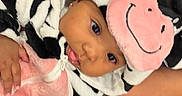 Iridessa is registered to the contest to win money with this photo: baby, child, cow_costume, hood, pink, black_and_white, plush, animal_print, leopard_print, zebra_toy, indoor, person, cute, costume, face, smile, hand, cozy, carpet, floor
