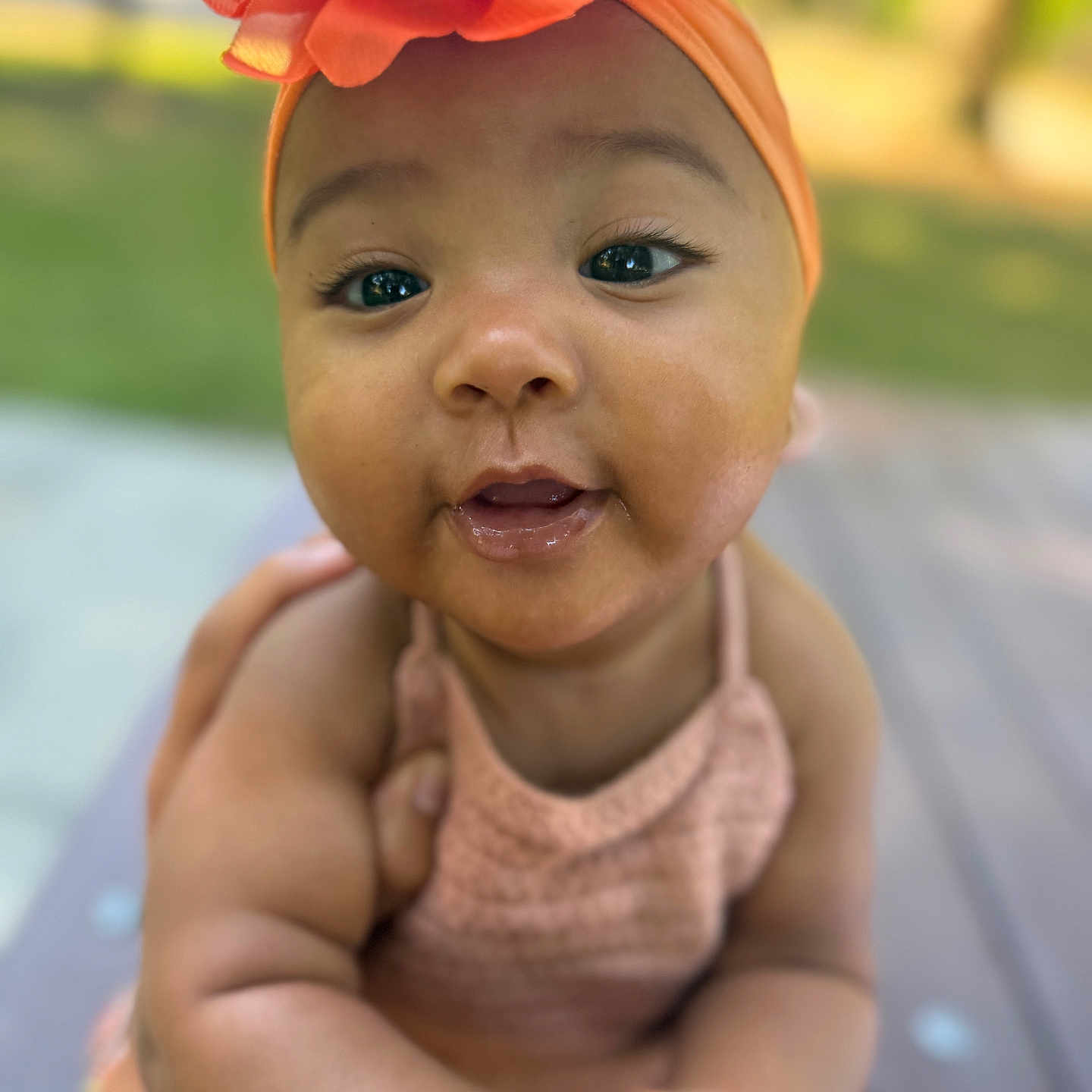 Iridessa is registered to the contest to win money with this photo: baby, infant, child, face, headband, flower, smile, outdoor, skin, arm, hand, cute, portrait, person, young, happy, closeup, nature, background, warm