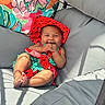 Iridessa joined the competition — help win amazing prizes! baby, child, smiling, hat, colorful_clothing, watermelon_theme, cushion, chair, indoor, sunlight, shadow, happy, cute, playful, pillow, patterned_pillow, relaxing, infant, portrait, cozy