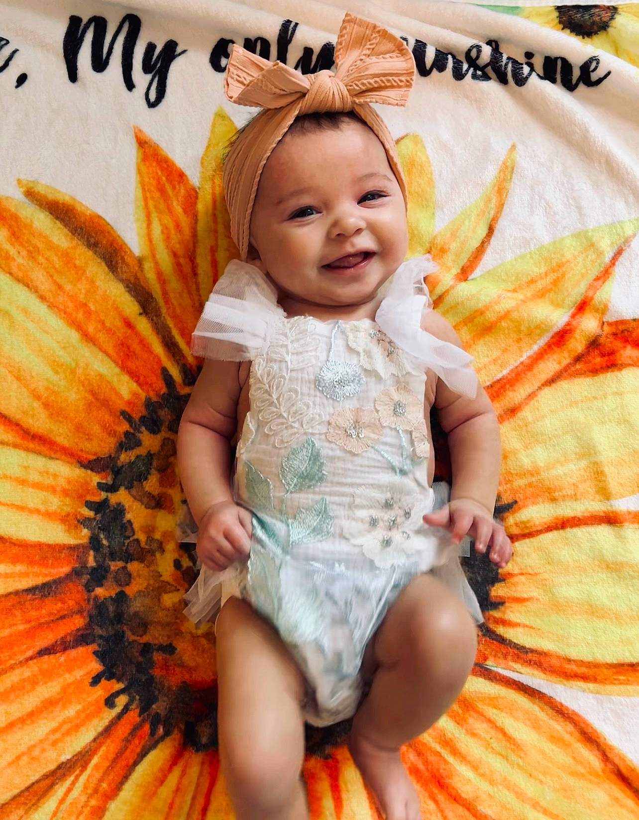 Amiyah is registered to the contest to win money with this photo: baby_toddler_clothing, calabaza, child, couch, dress, eye, facial_expression, fun, happy, head, human_body, joy, leaf, orange, organ, person, plant, pumpkin, smile, thigh