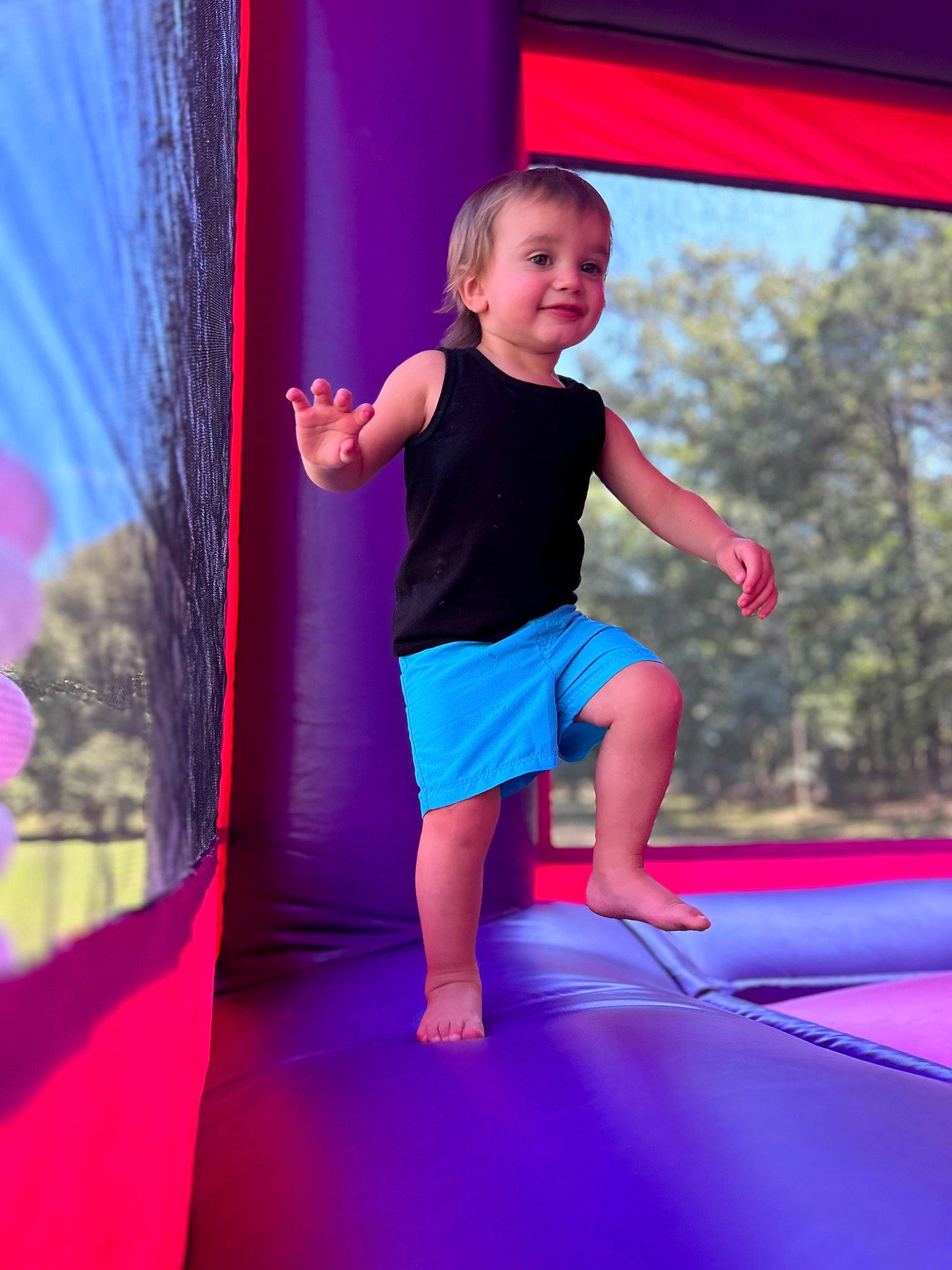 Robert is registered to the contest to win money with this photo: baby_toddler_clothing, bounce_house, child, electric_blue, entertainment, fun, happy, inflatable, joy, leisure, magenta, outdoor_play_equipment, person, pink, playground, purple, recreation, red, smile, t_shirt