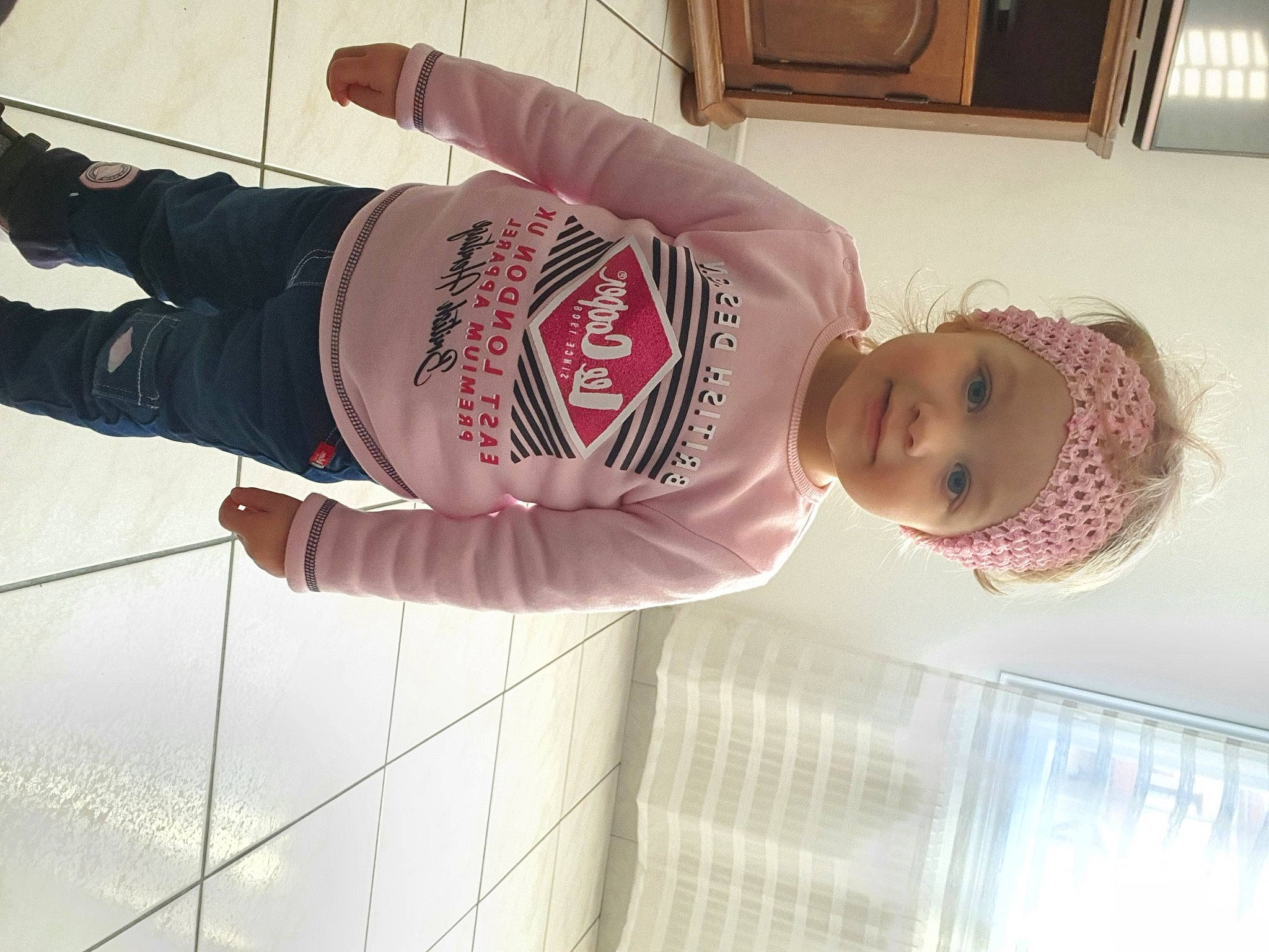 Victoria participe au concours pour gagner de l'argent avec cette photo : baby, baby_toddler_clothing, elbow, facial_expression, fun, headgear, headwear, human_leg, joy, knee, pattern, person, pink, room, sleeve, smile, textile, thigh, toddler, trunk