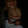 Jaiceon joined the competition — help win amazing prizes! baby, child, infant, smiling, portrait, sitting, indoor, dark, low_light, blanket, white_blanket, diaper, bare_arms, face, eyes, nose, mouth, happy, nighttime, close_up