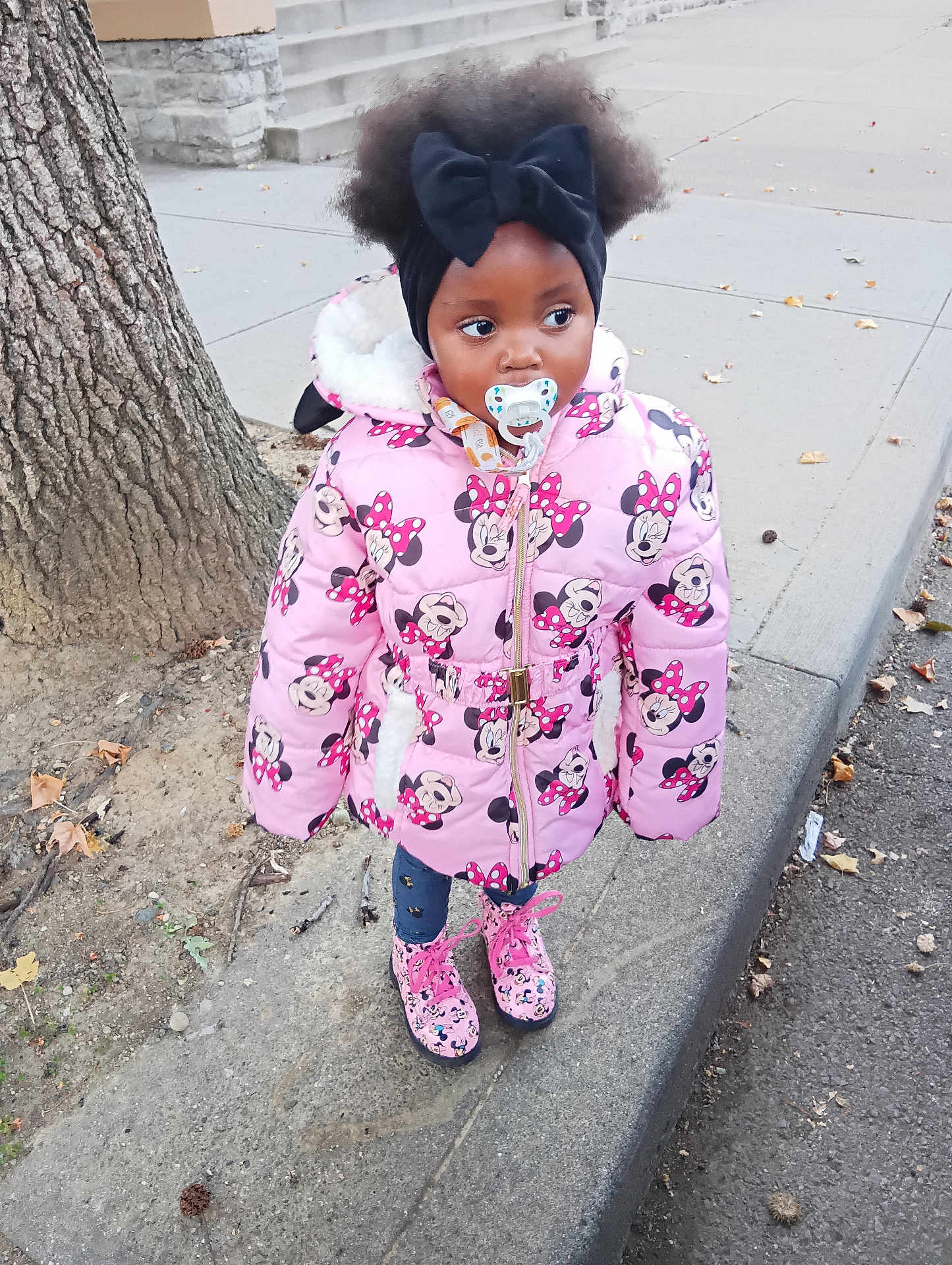 Xena is registered to the contest to win money with this photo: child, city, clothing, coat, face, female, girl, head, hood, jacket, path, person, photography, plant, portrait, road, sidewalk, street, toy, urban
