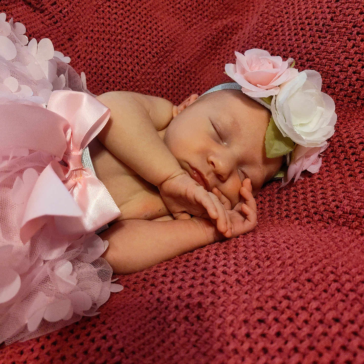 Elsie is registered to the contest to win money with this photo: baby, bodypart, bonnet, clothing, face, finger, flower, flowerarrangement, flowerbouquet, hand, hat, head, newborn, person, petal, photography, plant, portrait, rose, sleeping