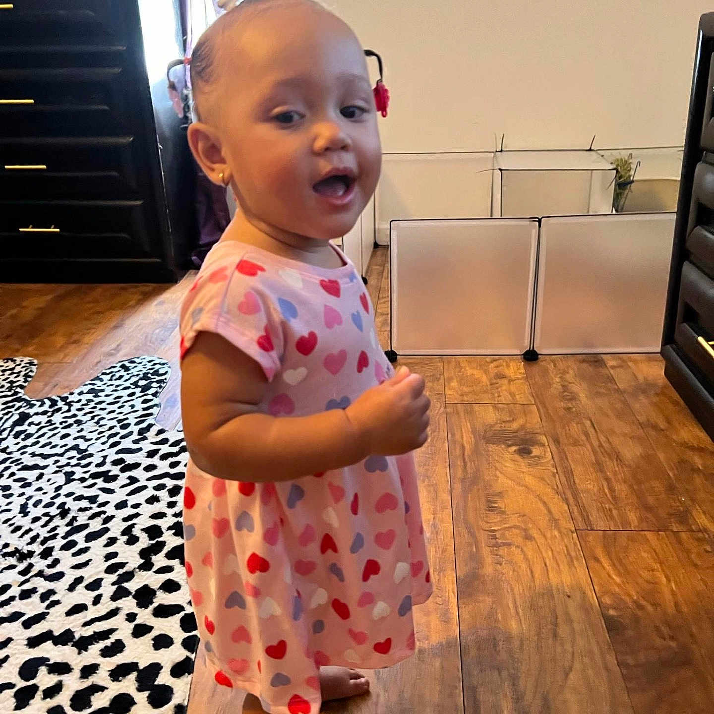 Alaina is registered to the contest to win money with this photo: baby, babylaughing, clothing, dress, face, furniture, happy, hardwood, head, indoors, interiordesign, person, photography, portrait, sitting, sleeve, smile, standing, whiteboard, wood