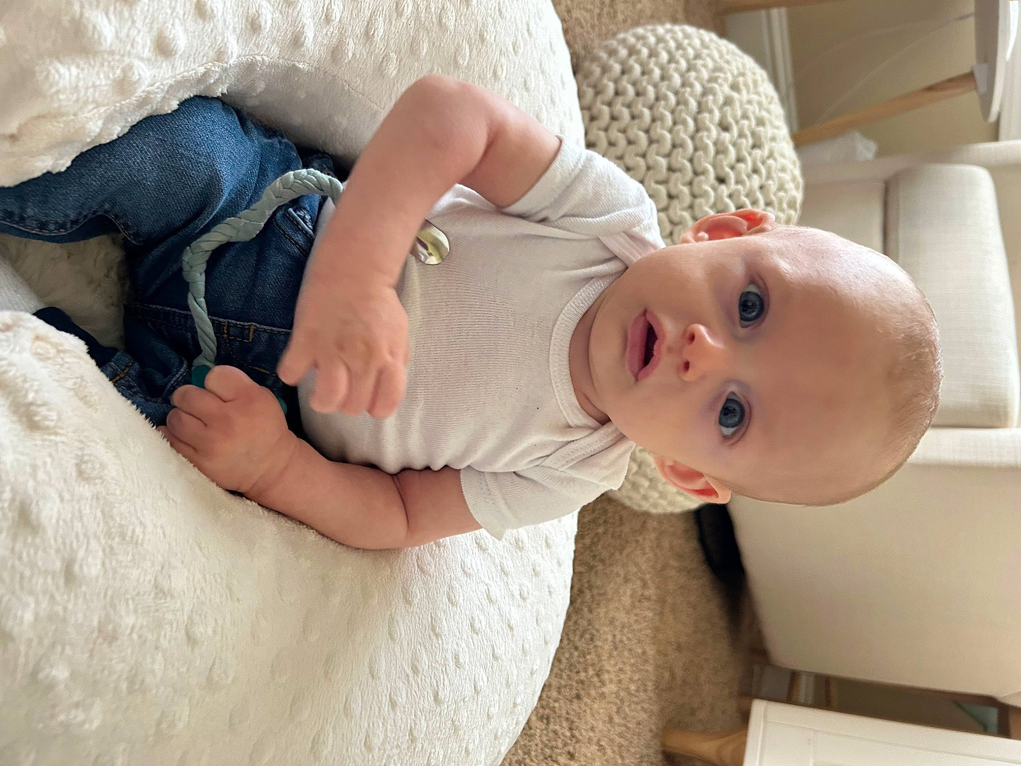 David is registered to the contest to win money with this photo: abdomen, arm, baby, baby_sleeping, baby_toddler_clothing, child, comfort, dress, finger, hand, happy, human_leg, leg, linens, person, product, sitting, skin, sleeve, surprise