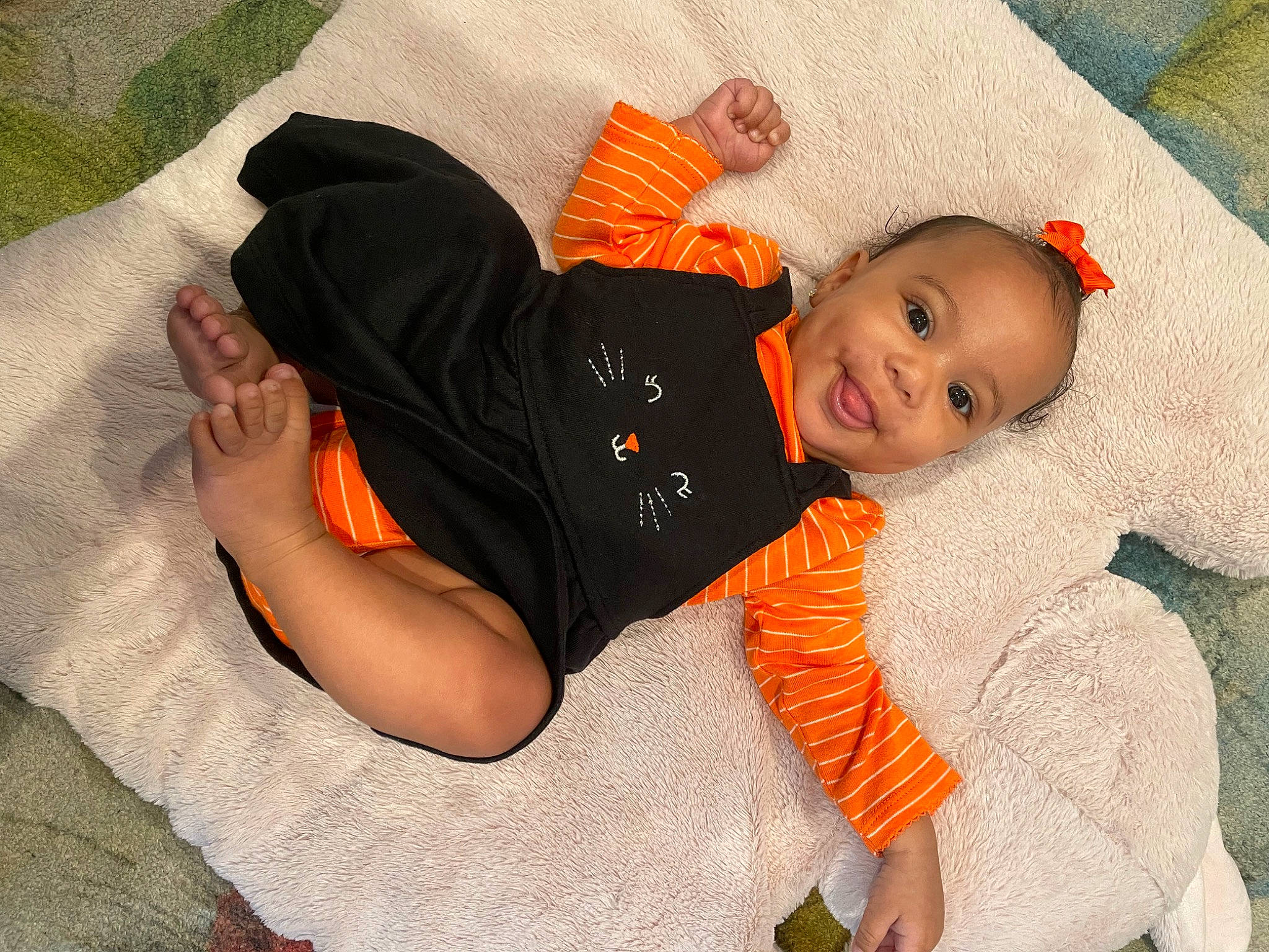 Soraya joined the competition — help win amazing prizes! baby, baby_products, baby_toddler_clothing, bedtime, child, comfort, fun, grass, happy, joy, lap, linens, orange, person, sitting, sleeve, smile, sock, t_shirt, thigh