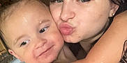 Kyler James joined the competition — help win amazing prizes! child, adult, hot_tub, water, hug, wet, face, smile, kiss, skin, arm, person, wood, indoor, bath, playful, closeup, expression, family, affection