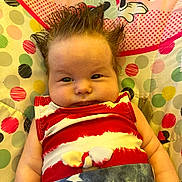 Adalynn Rose joined the competition — help win amazing prizes! baby, child, infant, spiky_hair, red_white_blue_clothing, stars, polka_dots, mickey_mouse, minnie_mouse, cushion, colorful, patterned, portrait, face, cute, indoors, sitting, person, young_child, expression